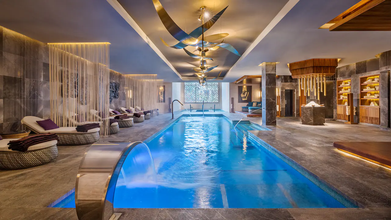 Luxury indoor hydrotherapy pool at Hyatt Zilara Cancun spa featuring tranquil lighting and modern wellness amenities.
